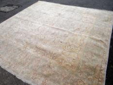 LARGE PALE FAWN WOOLEN RUG with central floral decoration and border, 300 x 300cms, together with