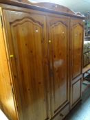 HONEY PINE TRIPLE WARDROBE WITH SINGLE DRAWER TO BASE together with a matching two-drawer dressing