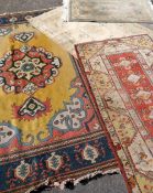 FOUR VARIOUS RUGS the largest a Turkish knotted yellow and blue ground woolen ETC, 287 x 198cms, 151