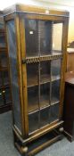 VINTAGE DARK OAK SINGLE GLAZED DOOR CABINET on a raised bobbin and stretcher base