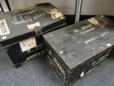TWO BLACK METAL TRAVEL TRUNKS, one dome topped with travel stickers relating to the SS Rhodesia