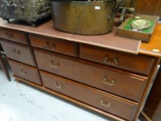 MODERN DARK WOOD RAILBACK SIDEBOARD with seven drawers to the front, 142cms wide