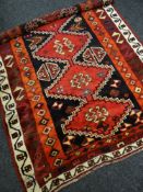 MULTI-COLOURED THICK WEAVED WOOLLEN PERSIAN RUG with four lozenge centre decoration and geometric