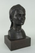 MODERN BRONZE BUST OF A FEMALE possibly Caribbean wearing head scarf, on a square based plinth,
