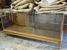 GOOD VINTAGE LIGHT OAK SHOP DISPLAY CABINET with single glass shelf, glass top and sliding glass