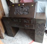 VINTAGE HARDWOOD DROP DOWN BUREAU with deep Oriental carving to the front drawers and side supports,