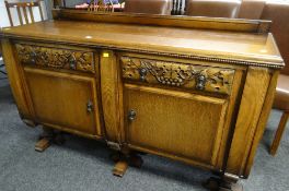 GOOD VINTAGE RAIL BACK OAK SIDEBOARD with carving to the drawers on raised feet