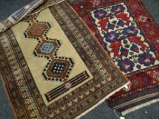 MAINLY BLUE & RED GROUND BORDERED PERSIAN-STYLE RUG with floral decorated centre, 140 x 85cms
