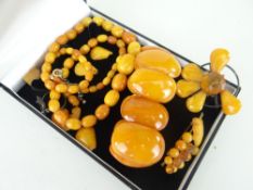 PARCEL OF AMBER JEWELLERY including graduated strand of beads, brooches ETC