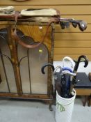 VINTAGE SET OF EIGHT GOLF CLUBS IN CARRY CASE, together with a ceramic umbrella stand and