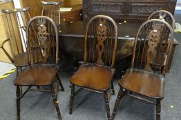 DARK OAK REFECTORY-STYLE DROP LEAF DINING TABLE, together with four Prince of Wales feathered and