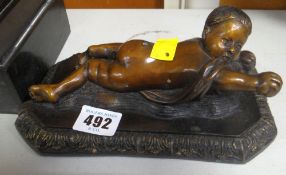 COLD CAST MODEL OF A RECLINING CHILD, signed 'Della Robbia'