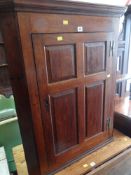 ANTIQUE OAK PANELLED HANGING CORNER CUPBOARD with three-shelf interior
