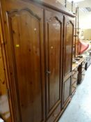 PINE TRIPLE WARDROBE WITH DRAWER BASE together with a pine dressing table and stool