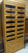 GOOD VINTAGE LIGHT OAK DRAPER'S CABINET fitted with sixteen glass fronted drawers to the top by