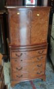 MAHOGANY BOW FRONT CABINET with cupboard top above a four drawer base, 130cms high x 60cms wide