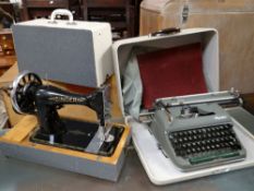 CASED SINGER SEWING MACHINE together with a vintage cased Olympia typewriter (2)