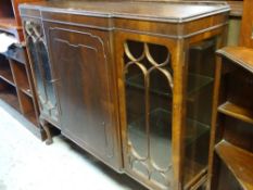 VINTAGE MAHOGANY BREAKFRONT CABINET with centre cupboard flanked by two astragal glazed doors on