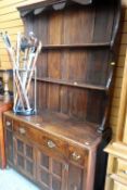VINTAGE DRESSER having paneled two cupboard base, three drawers and open rack, 122cms wide