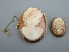 A LARGE OVAL 9CT GOLD CAMEO BROOCH with safety pin and head and shoulders depiction of a young lady,