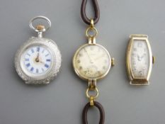 TWO 9CT GOLD CASE LADY'S WRIST WATCHES, one with leather strap and a silver case lady's fob watch