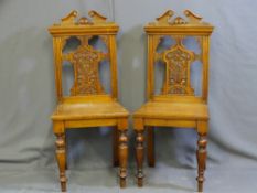TWO MAHOGANY HALL CHAIRS with carved and shaped backs
