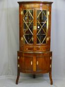A MAHOGANY STANDING CORNER CUPBOARD, early to mid 20th century two piece bow front, the upper