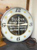A BULOVA REPAIR SERVICE ADVERTISING CLOCK, stamped November 1956, to the edge