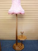 A CRAFTED WOODEN STANDARD LAMP with incorporated side table