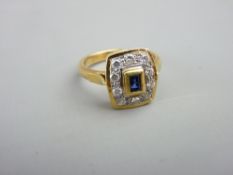 AN 18CT GOLD DIAMOND & SAPPHIRE DRESS RING having a small oblong cut centre sapphire with ten