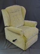 A LIGHT FLORAL UPHOLSTERED AND RECLINING EASY CHAIR