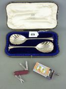 A CASED PAIR OF SILVER SERVING SPOONS - London 1907, 3.9 troy ounces, a windup musical match box and