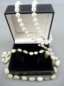 A NECKLACE OF UNIFORMED CIRCULAR PEARLS and a mother of pearl style necklace with white metal clasp
