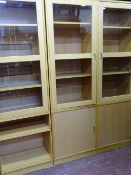 A MODERN LIGHT WOOD AND GLAZED DISPLAY CABINET system of separate items