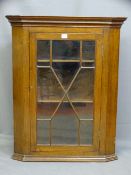 A SINGLE DOOR GLASS PANED MAHOGANY HANGING CORNER CUPBOARD, 89cms height, 72cms width