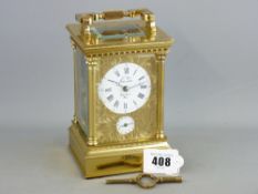 A FRENCH BRASS REPEATING CARRIAGE CLOCK, chase decorated front and white dial set with Roman