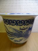 A CHINESE EXPORT BLUE & WHITE POTTERY JARDINIERE depicting phoenix and dragons chasing flaming