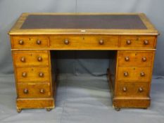 A VICTORIAN MAHOGANY PEDESTAL WRITING DESK having an original sham leather top and a centre