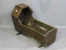 A CHILD'S PINE ROCKING CRADLE with shaped hood, length 89cms