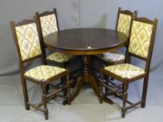 A CIRCULAR EXTENDING DINING TABLE and four floral upholstered dining chairs