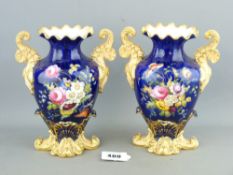 A PAIR OF EARLY HAND PAINTED PORCELAIN VASES, unmarked, having floral sprays on a cobalt ground with