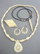 AN IVORY BEAD NECKLACE with carved pendant, a pair of circular ivory moon shaped earrings, a diamond