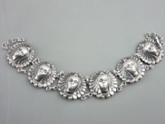 A BELIEVED SILVER BRACELET of six female mask links, 25.5gms