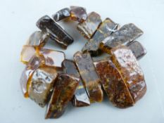 AN AMBER STRUNG BRACELET of sixteen large rock effect pieces, 43.5gms