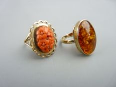 A 9CT GOLD OVAL AMBER DRESS RING, 2 x 1.3cms, 4.8gms gross, size P/Q and a 9ct gold oval coral dress