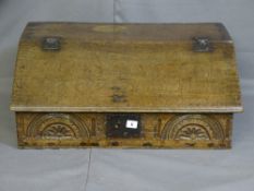 AN OAK BIBLE BOX, late 18th/early 19th century with iron hinges to the slope and a carved lunette