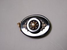 AN OVAL MOURNING PENDANT with centre pearl star cluster and gold hook and eye
