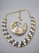 A YELLOW METAL LEAF SHAPED PIN BROOCH and a yellow metal pearl and green stone double strand