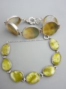 A WHITE METAL BRACELET of five large mother of pearl disc shaped links and a white metal necklace of