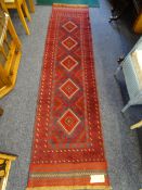 A MESHWANI RUNNER red ground with repeating central diamond pattern and continuous border, 260 x